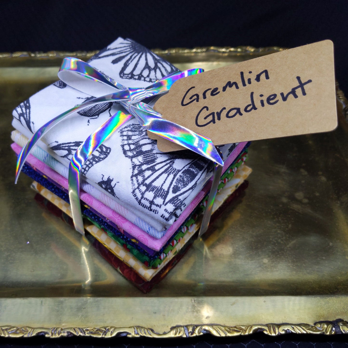 Stack of colorful gradient cards with a decorative box on a dark background