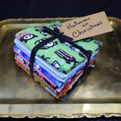 Stack of colorful fabric pouches with a green one featuring a face design on a gold tray.