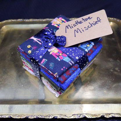Stack of colorful fabric squares with a label on a metallic surface