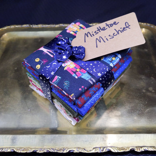 Stack of colorful fabric squares with a label on a metallic surface