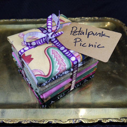 Colorful fabric items with a tag on a metallic surface